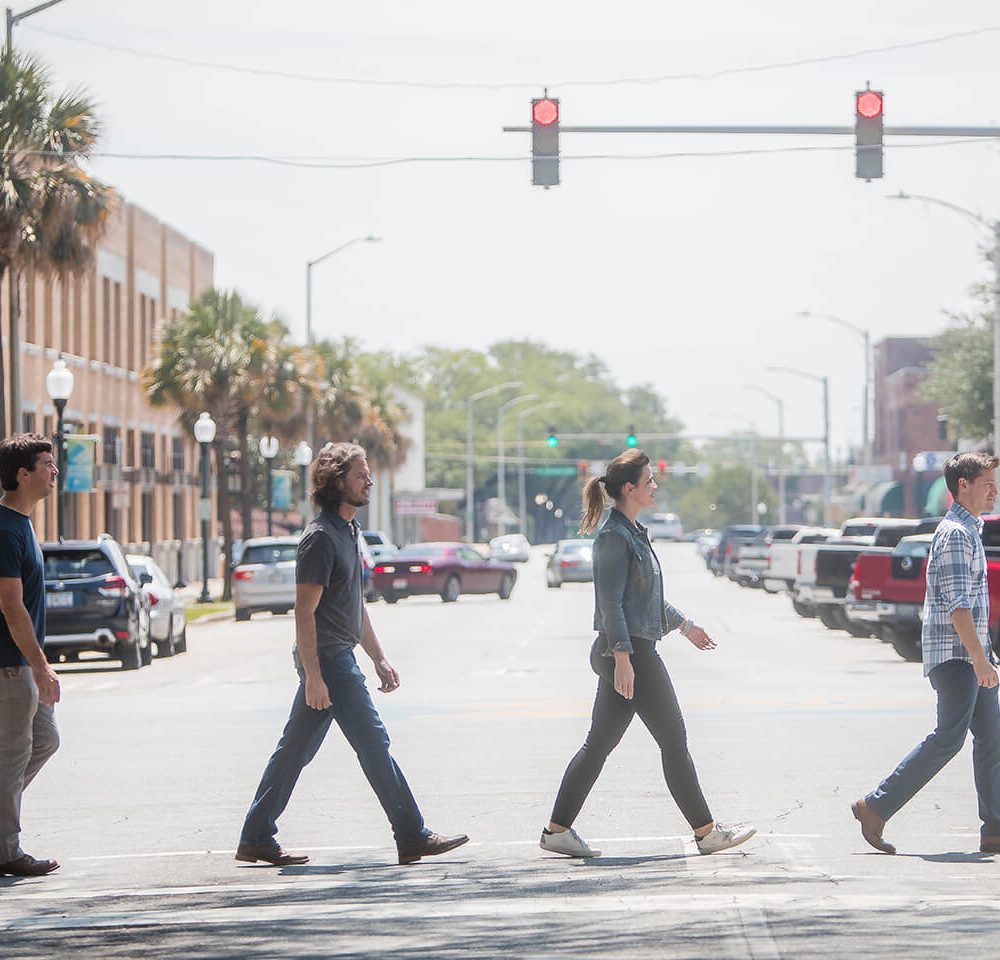 The Relative Media & Marketing team walks across a cross walk in Albany, Georgia mimicking the Beatle's Abbey Road photo.
