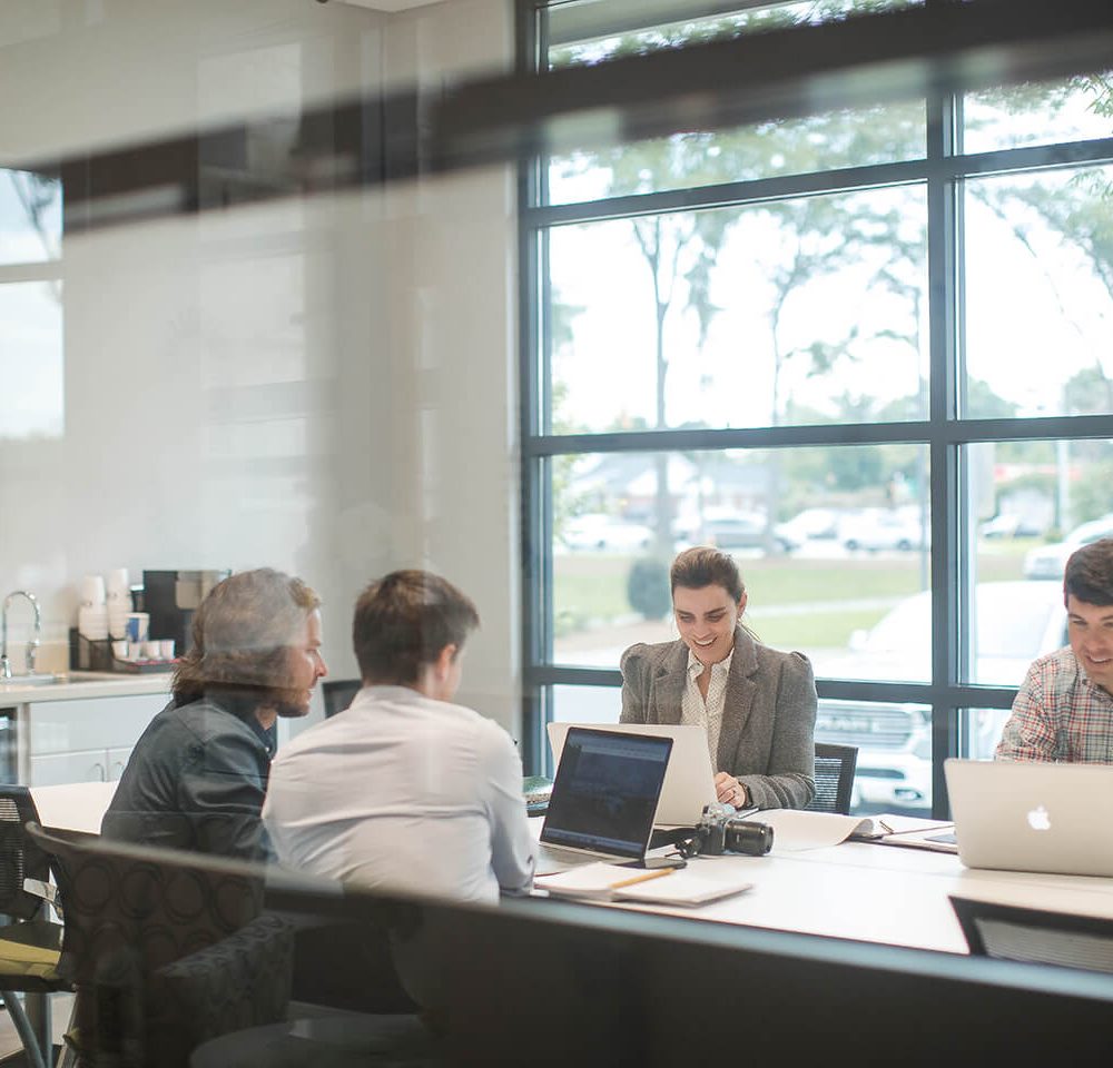 The Relative Media & Marketing looking through current work in a conference room.